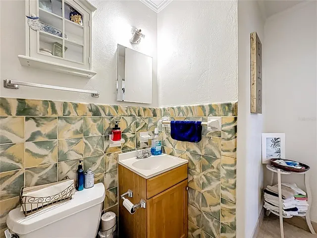 a living room with furniture a ceiling fan and a window