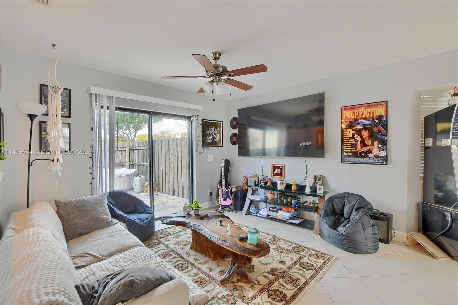 256 Southwest 6th Street, Unit 6 Boca Raton, FL 33432 - Photo 16 of 39 a living room with furniture or couch and a chandelier