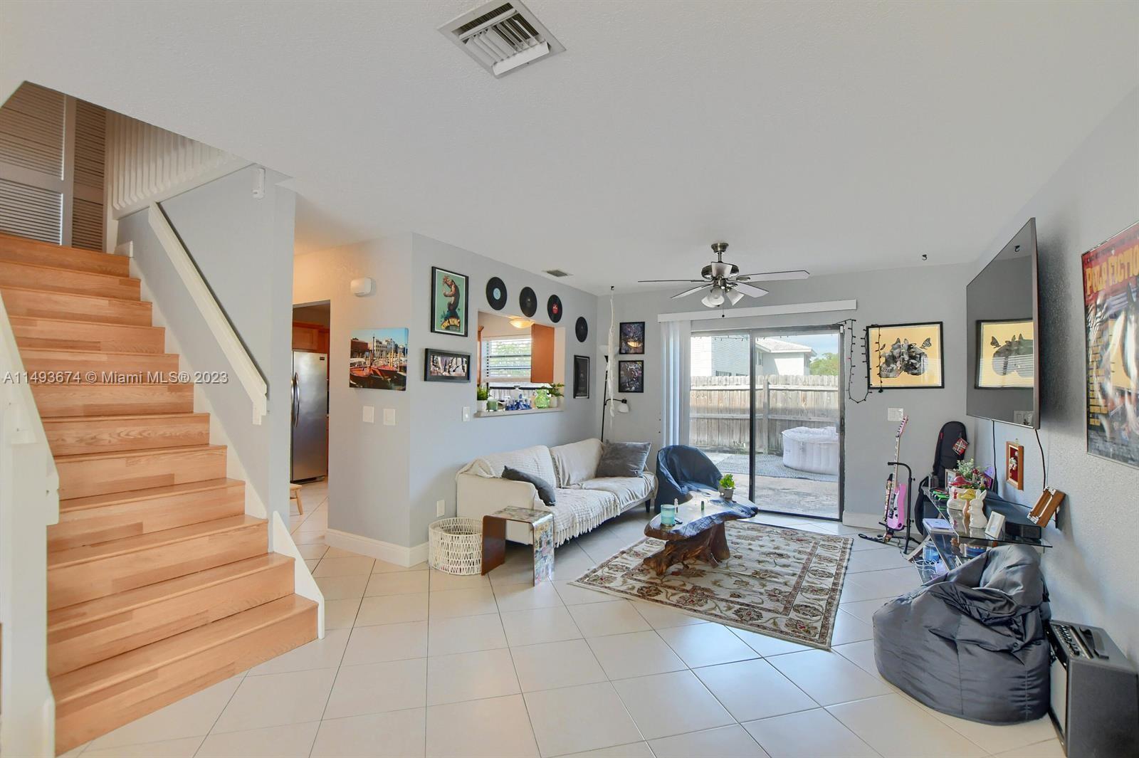 256 Southwest 6th Street, Unit 6 Boca Raton, FL 33432 - Photo 17 of 39 a living room with furniture and a chandelier