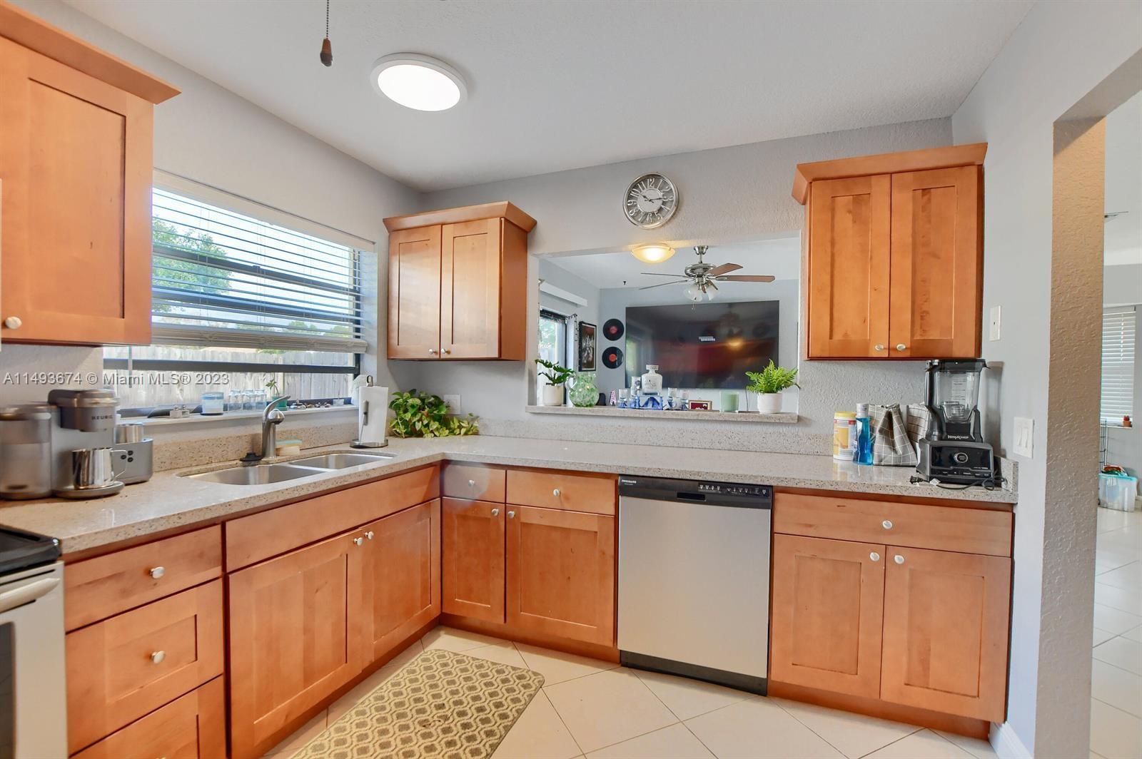 256 Southwest 6th Street, Unit 6 Boca Raton, FL 33432 - Photo 20 of 39 a kitchen with a sink window and cabinets