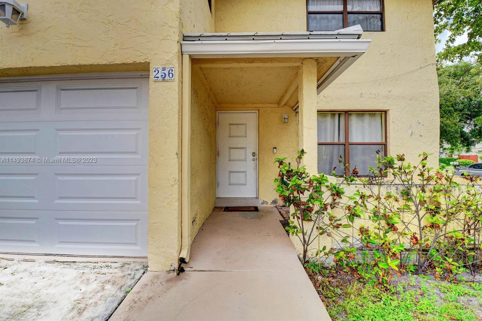 256 Southwest 6th Street, Unit 6 Boca Raton, FL 33432 - Photo 2 of 39 a view of entryway with wooden walls