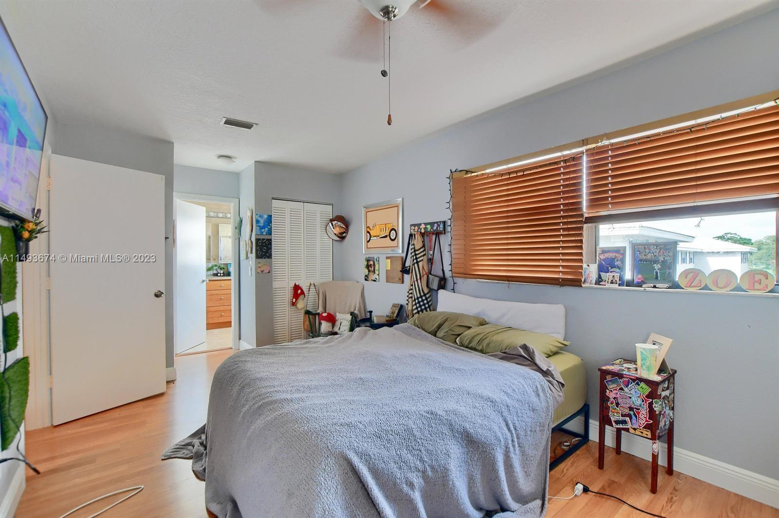 256 Southwest 6th Street, Unit 6 Boca Raton, FL 33432 - Photo 26 of 39 a bedroom with a bed and a window