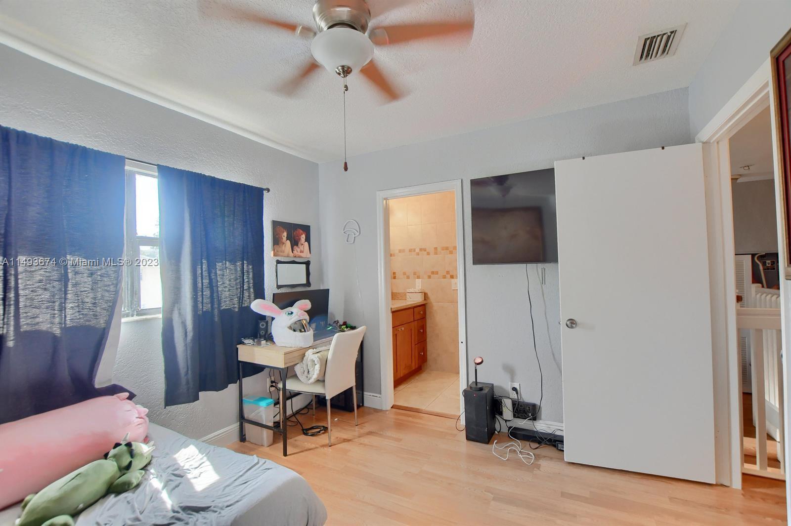 256 Southwest 6th Street, Unit 6 Boca Raton, FL 33432 - Photo 30 of 39 a living room with furniture and a chandelier