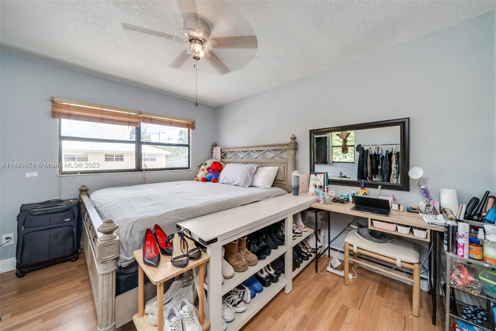 256 Southwest 6th Street, Unit 6 Boca Raton, FL 33432 - Photo 33 of 39 a bed room with a bed a dresser and a window