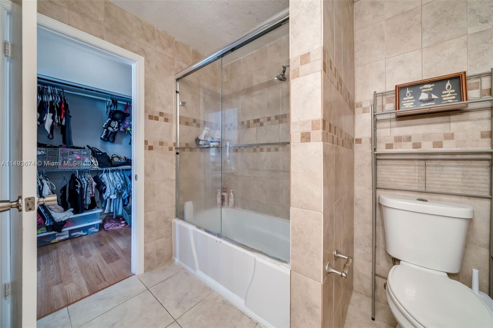 256 Southwest 6th Street, Unit 6 Boca Raton, FL 33432 - Photo 34 of 39 a bathroom with a shower a toilet and a sink