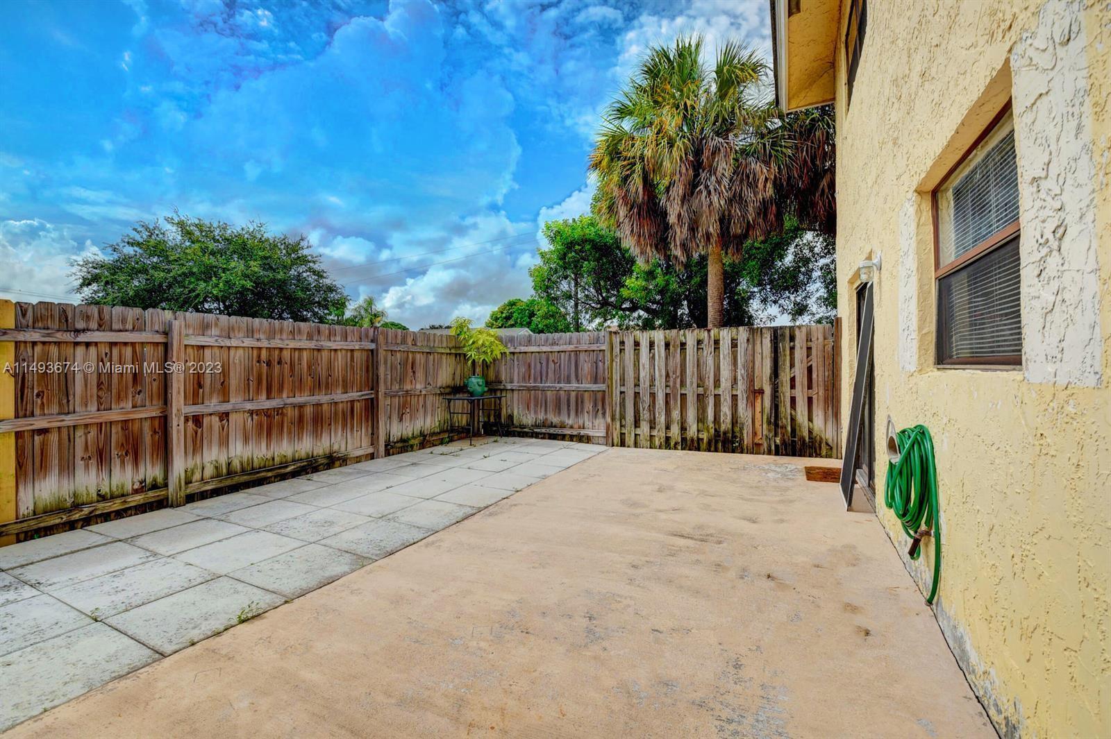 256 Southwest 6th Street, Unit 6 Boca Raton, FL 33432 - Photo 37 of 39 a view of backyard with wooden fence