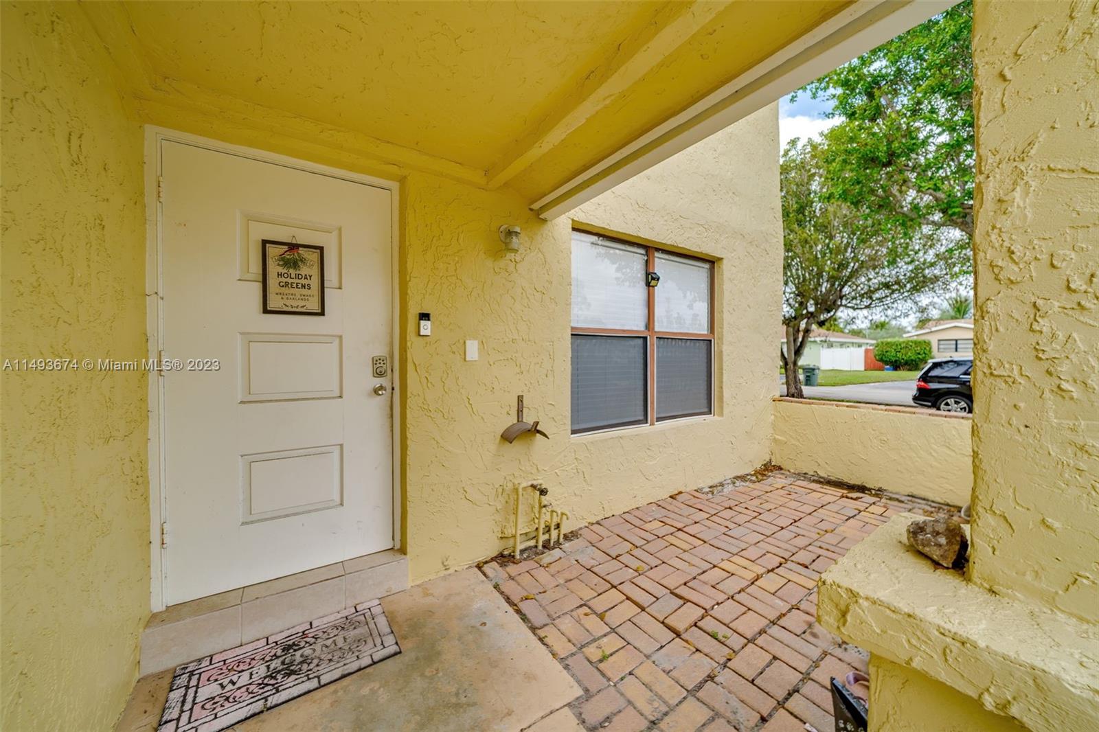 256 Southwest 6th Street, Unit 6 Boca Raton, FL 33432 - Photo 5 of 39 a bedroom with a bed and a window