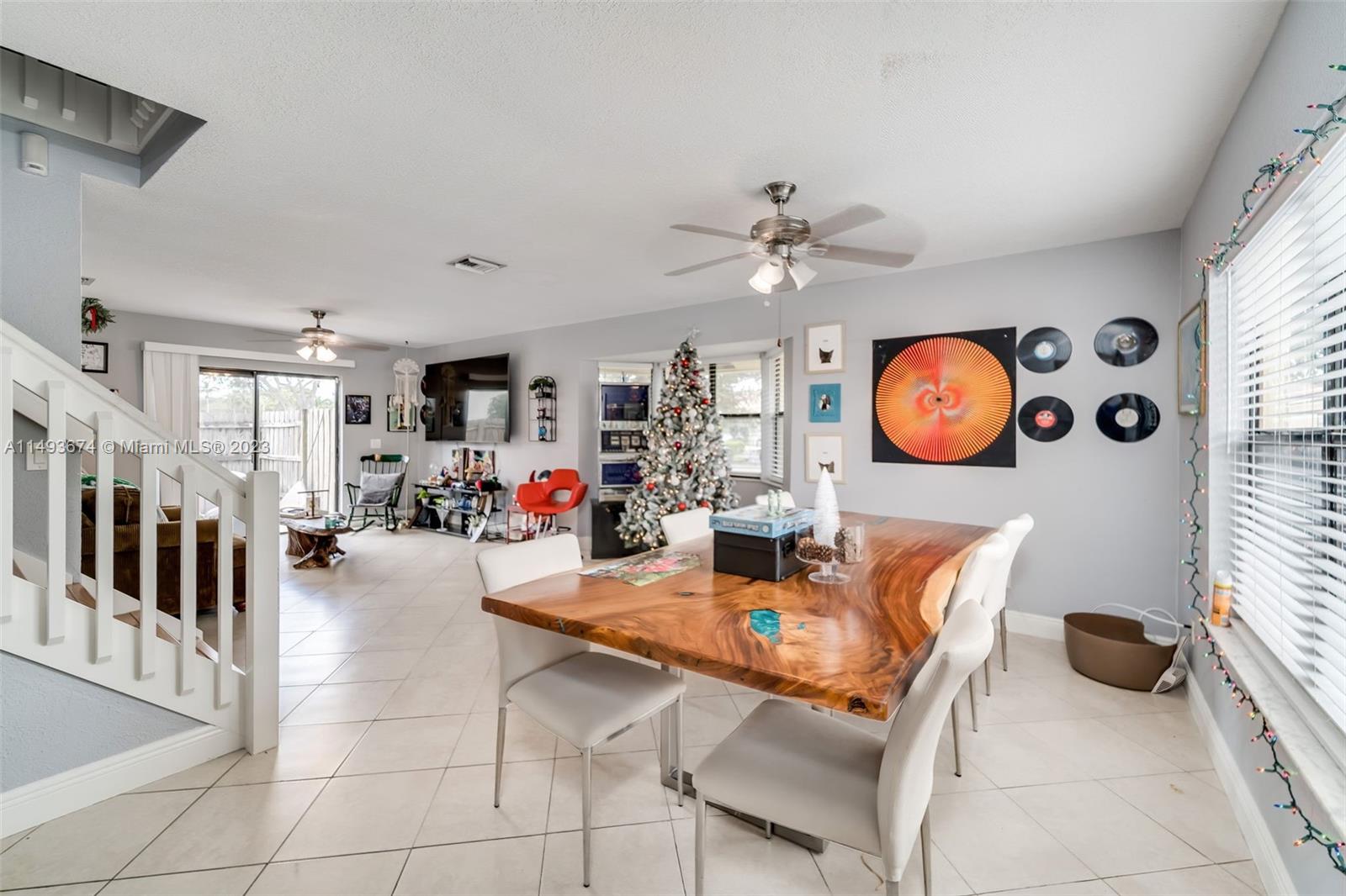 256 Southwest 6th Street, Unit 6 Boca Raton, FL 33432 - Photo 8 of 39 a view of a dining room and livingroom with furniture wooden floor and a clock