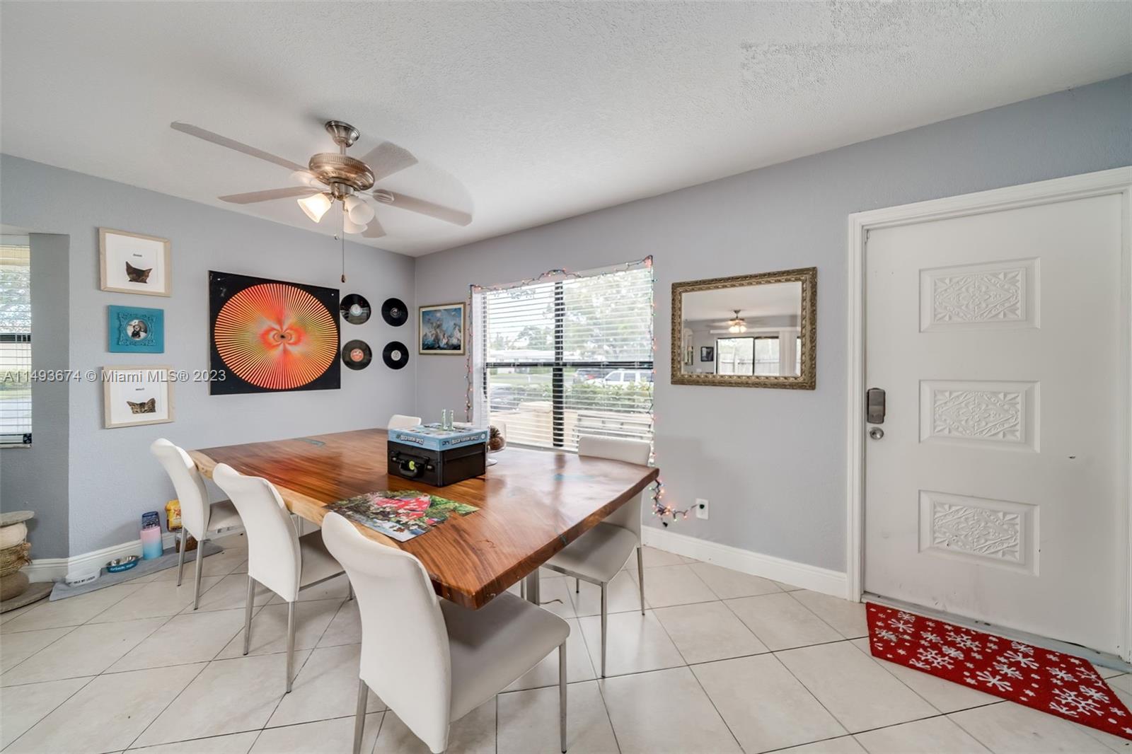 256 Southwest 6th Street, Unit 6 Boca Raton, FL 33432 - Photo 9 of 39 a view of a dining room with furniture and wooden floor