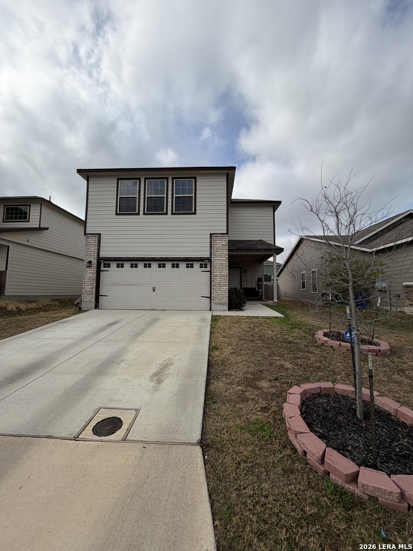 a front view of a house with a yard