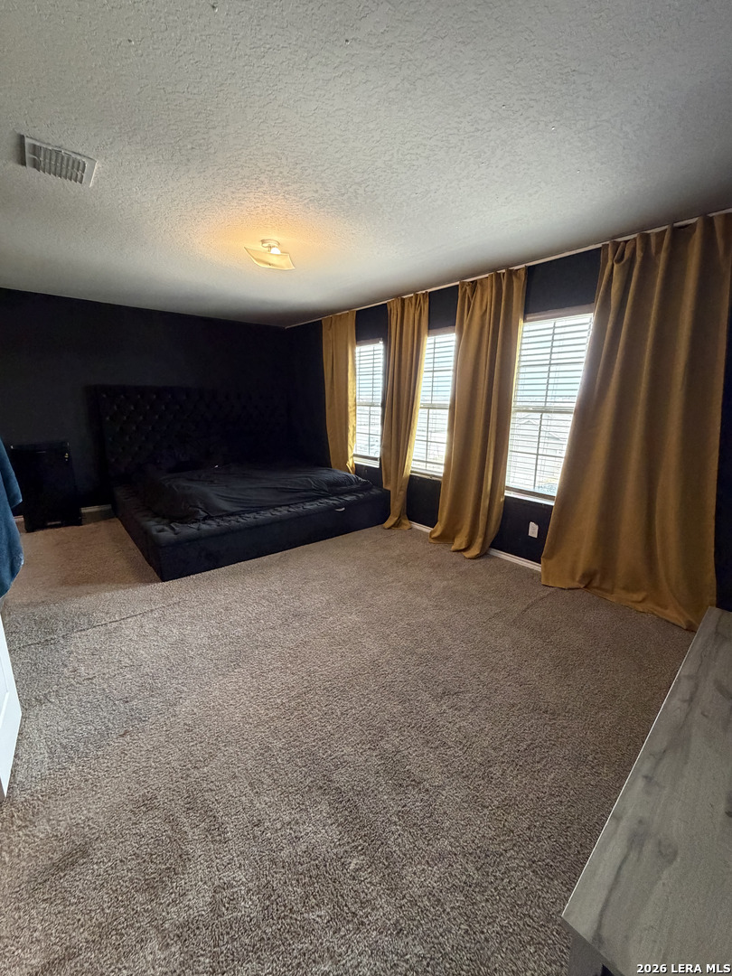 10814 Randolph Way Converse, TX 78109 - Photo 7 of 8 a view of an empty room with wooden floor and a window