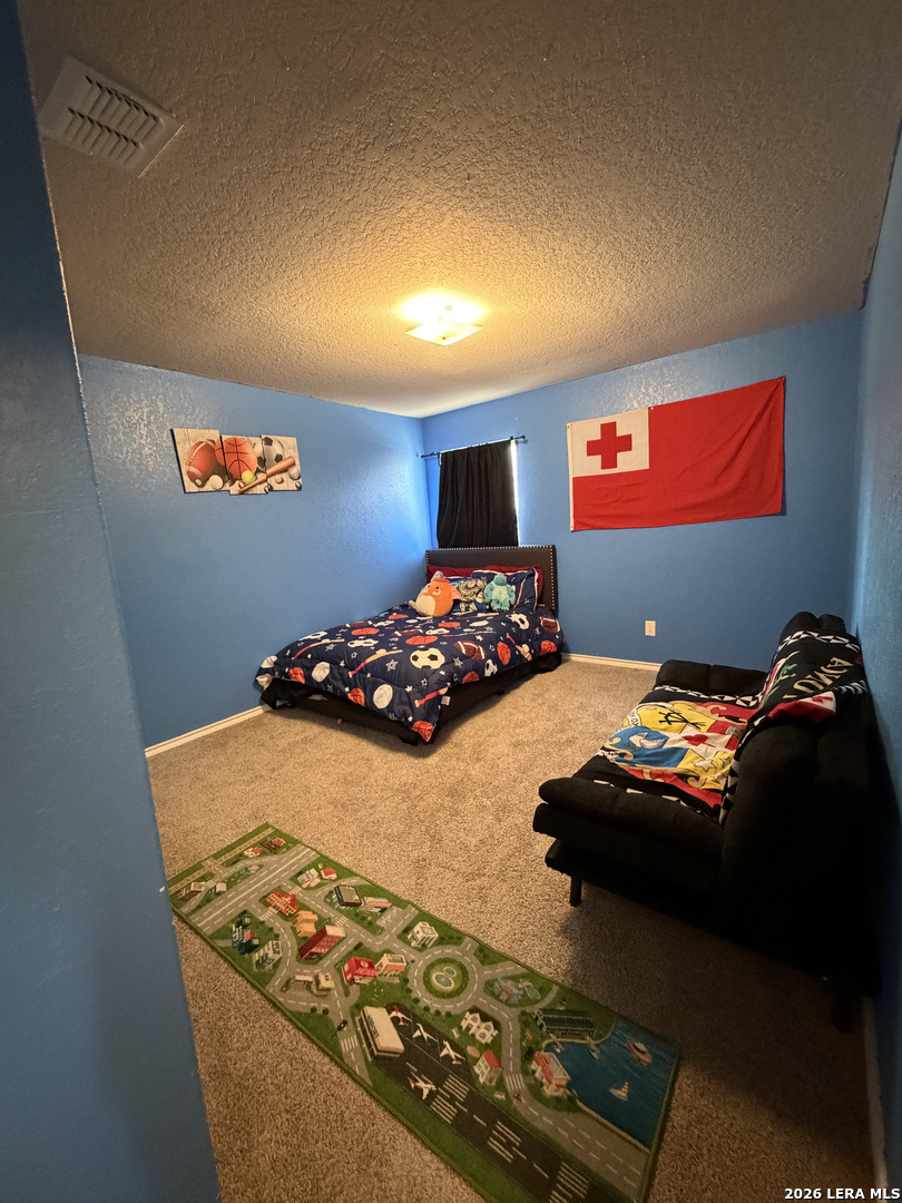 10814 Randolph Way Converse, TX 78109 - Photo 8 of 8 a bedroom with bed and a window