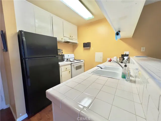 a kitchen with a stove a refrigerator and a sink