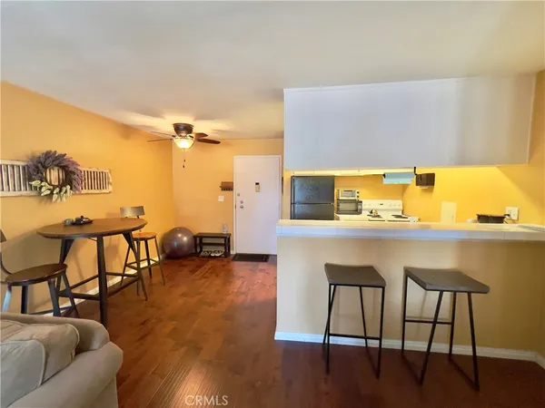 a large white room with a large window and furniture