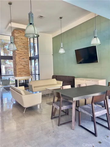 a living room with furniture a window and a flat screen tv