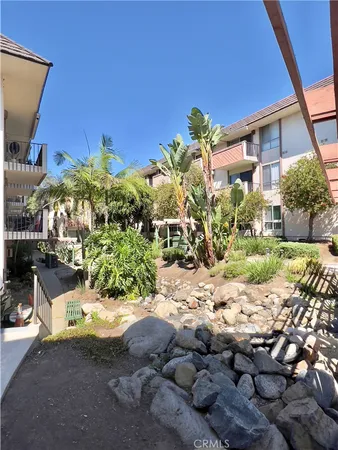 a building outdoor space with patio furniture and a potted plant