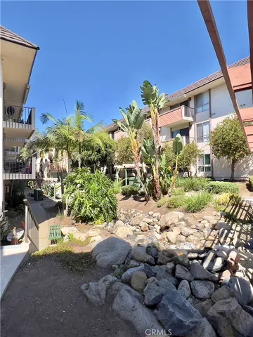 a building outdoor space with patio furniture and a potted plant