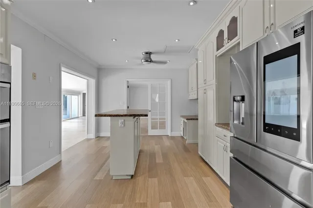 a view of a hallway with wooden floor and staircase