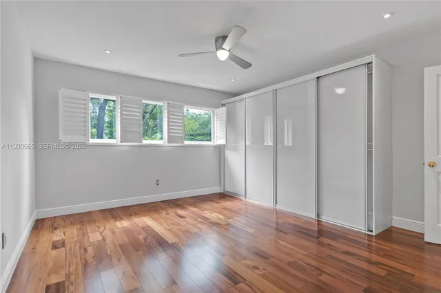 a view of a field with a trees in the background