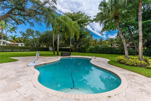 a view of a swimming pool with a yard