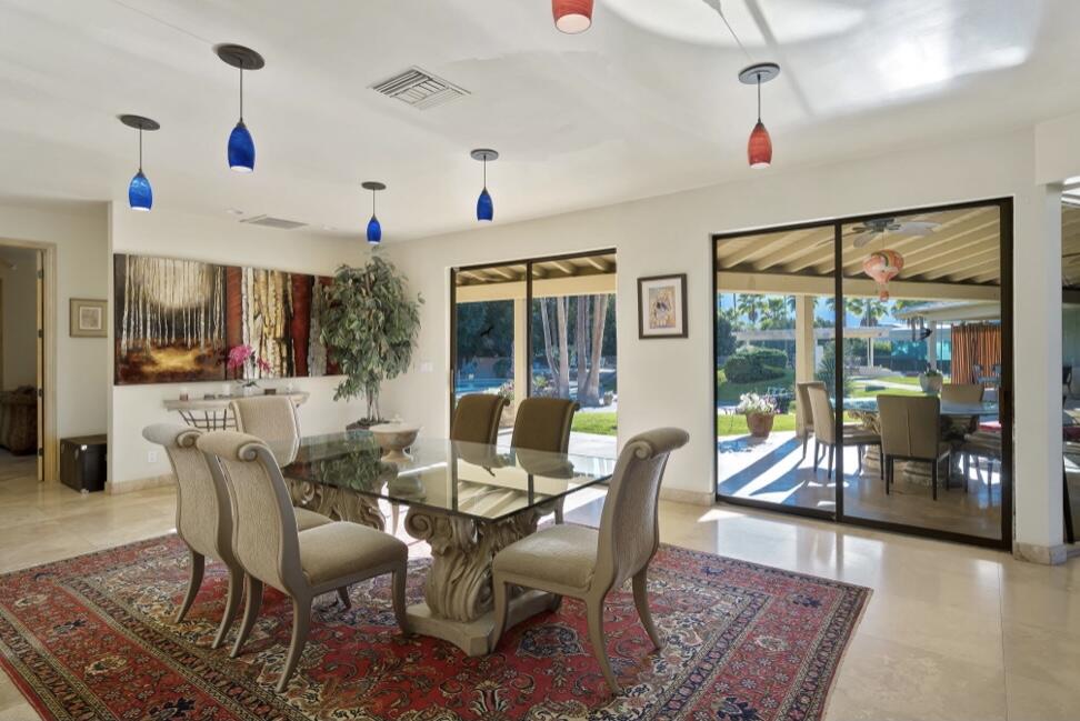 71111 La Paz Road Rancho Mirage, CA 92270 - Photo 13 of 102 a view of a dining room with furniture wooden floor and chandelier