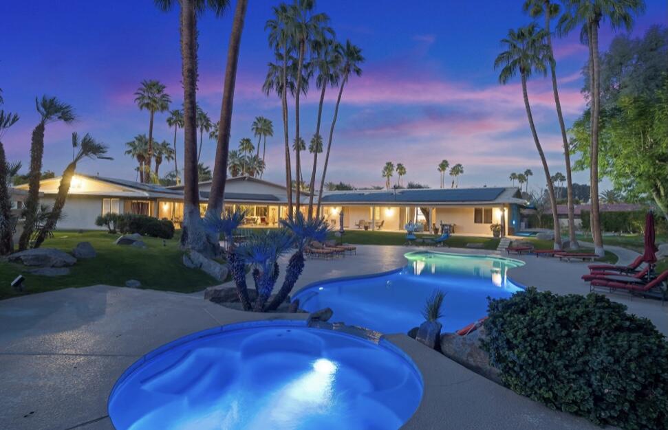 71111 La Paz Road Rancho Mirage, CA 92270 - Photo 2 of 102 a view of a swimming pool with a table and chairs