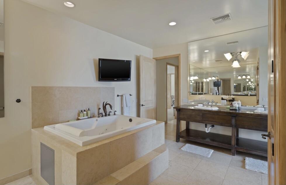 71111 La Paz Road Rancho Mirage, CA 92270 - Photo 24 of 102 a bathroom with a sink a large mirror and a bathtub