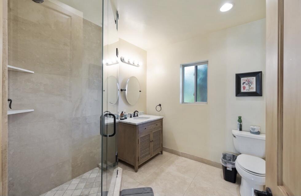 71111 La Paz Road Rancho Mirage, CA 92270 - Photo 33 of 102 a bathroom with a granite countertop sink a toilet and a mirror