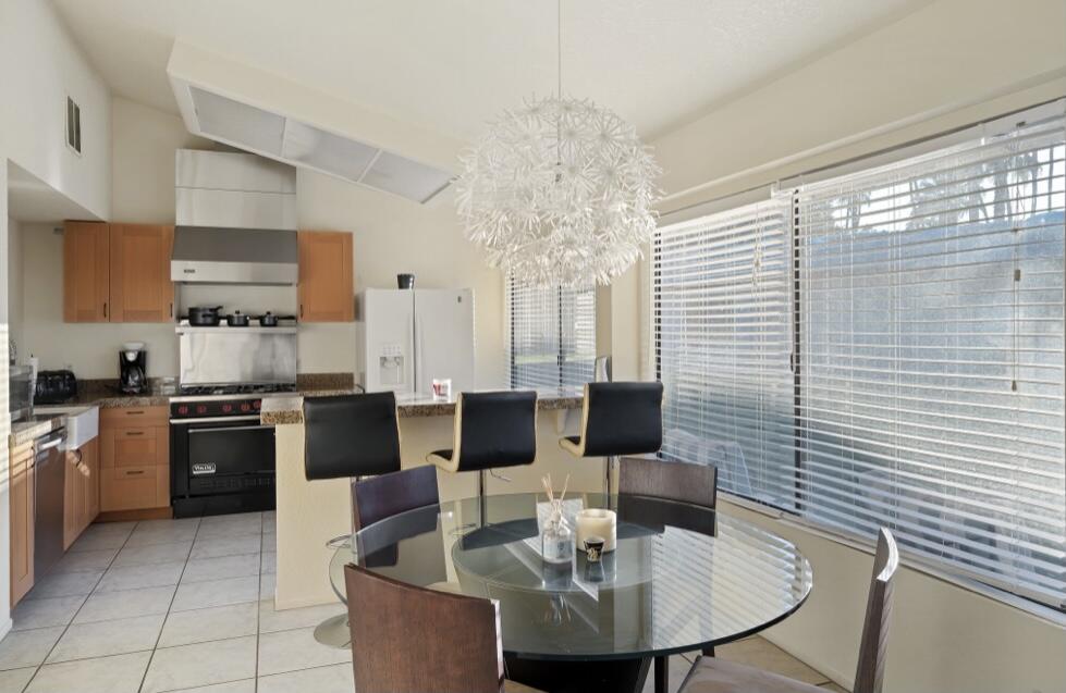 71111 La Paz Road Rancho Mirage, CA 92270 - Photo 63 of 102 a kitchen with stainless steel appliances kitchen island granite countertop a sink table and chairs