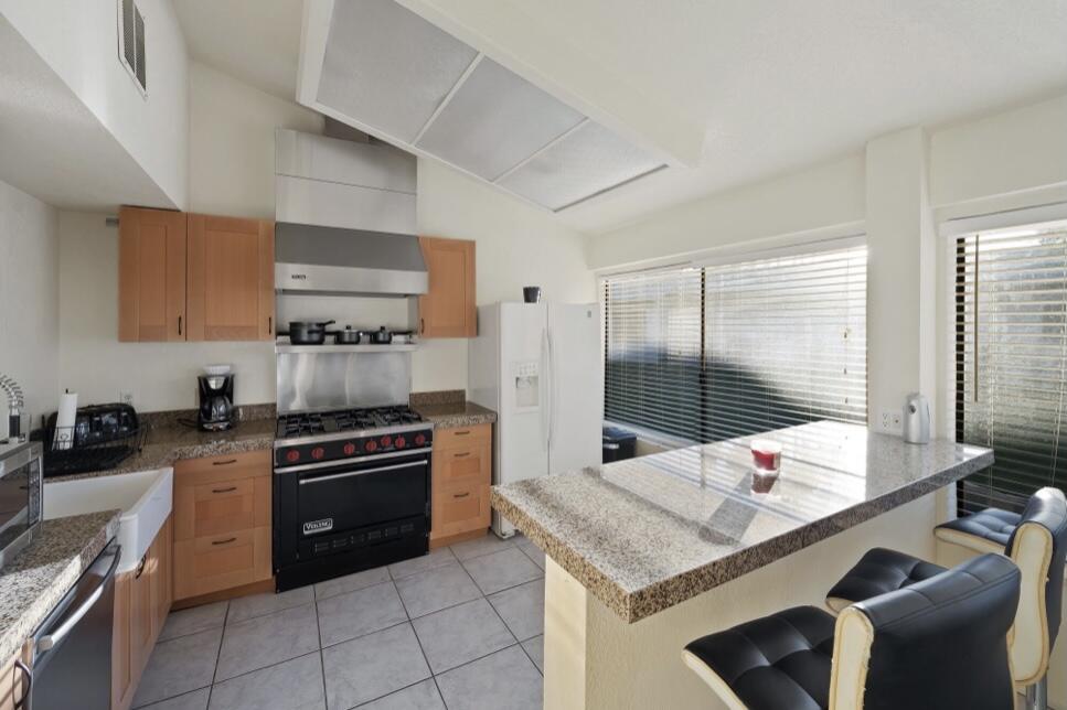 71111 La Paz Road Rancho Mirage, CA 92270 - Photo 64 of 102 a kitchen with stainless steel appliances kitchen island granite countertop a stove a sink and a refrigerator