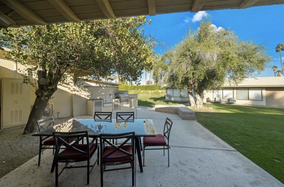 71111 La Paz Road Rancho Mirage, CA 92270 - Photo 70 of 102 a view of a chairs and table in patio next to a yard