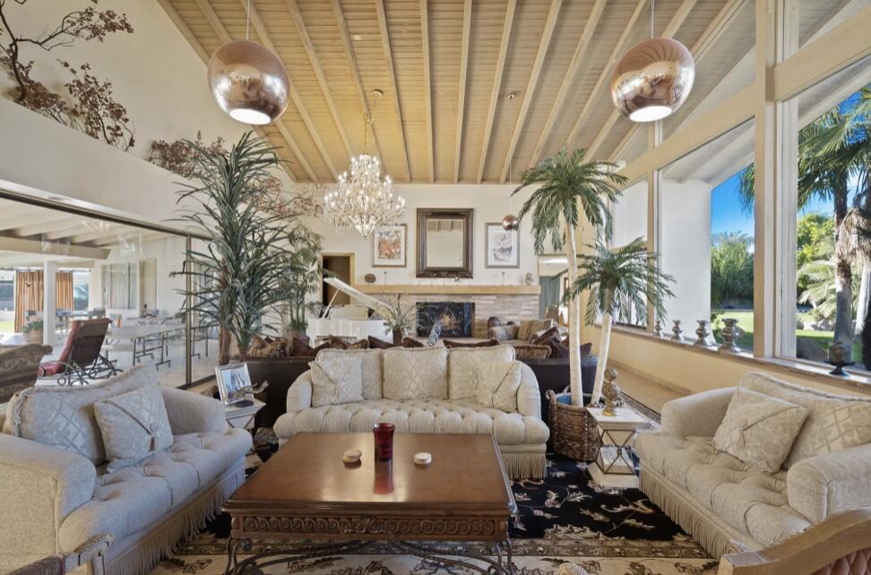 71111 La Paz Road Rancho Mirage, CA 92270 - Photo 7 of 102 a living room with furniture a large window and a fireplace
