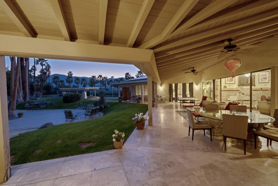 71111 La Paz Road Rancho Mirage, CA 92270 - Photo 89 of 102 a view of a patio with table and chairs potted plants and floor to ceiling window