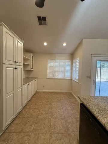 a kitchen with cabinets and wooden floor