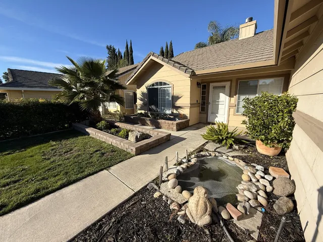 a view of a house with yard and patio