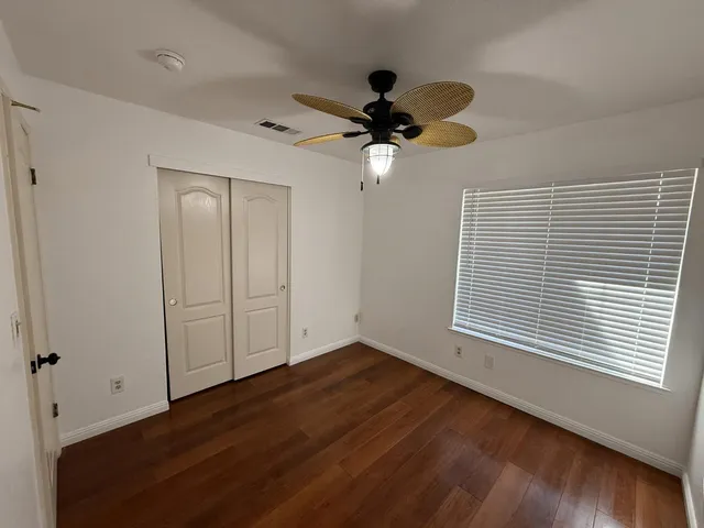 a bathroom with a granite countertop sink toilet and a mirror