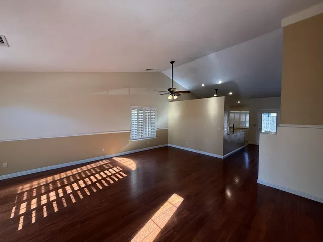 a view of wooden floor and windows in a room