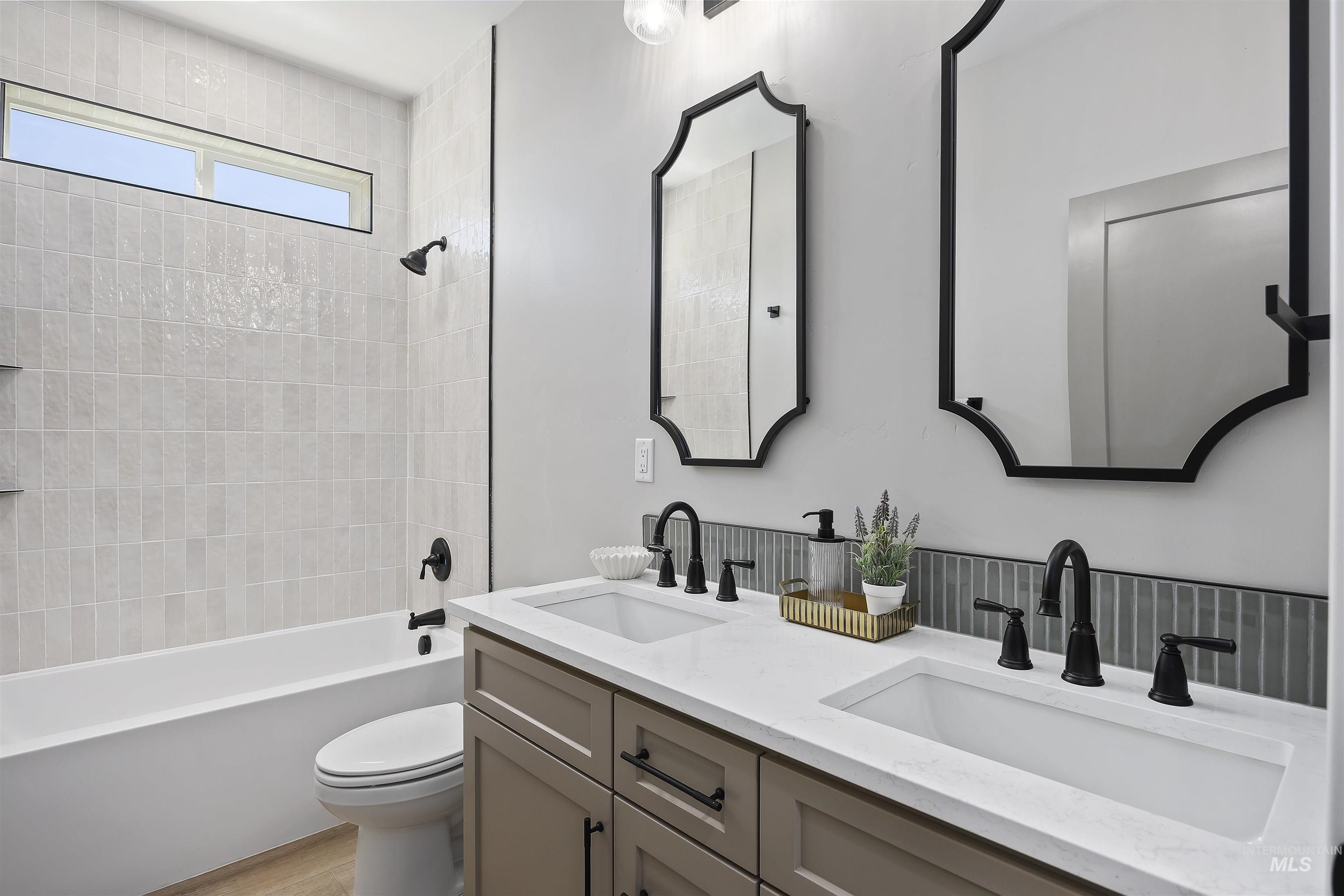 378 West 100 South Rupert, ID 83350 - Photo 33 of 50 Bathroom featuring a dual-sink vanity with white countertops, matte black fixtures, and decorative mirrors