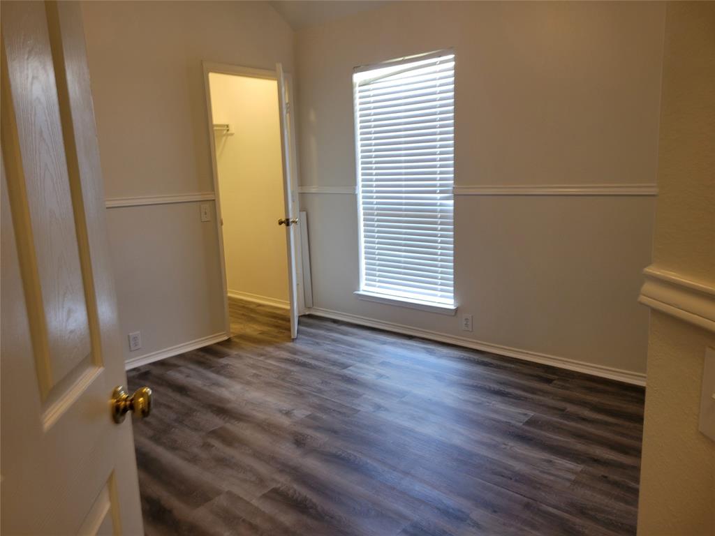 2913 Rush Creek Road McKinney, TX 75072 - Photo 15 of 32 3rd bedroom with large walk-in closet and new laminate flooring