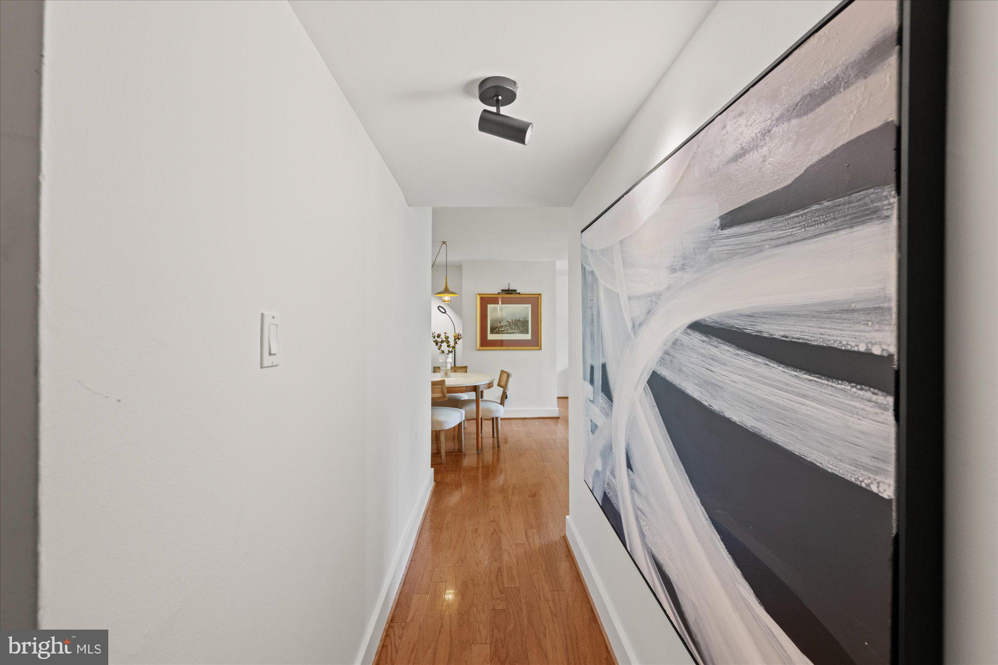 4840 MacArthur Boulevard Northwest, Unit 301 Washington, DC 20007 - Photo 2 of 24 a view of a hallway with wooden floor and staircase