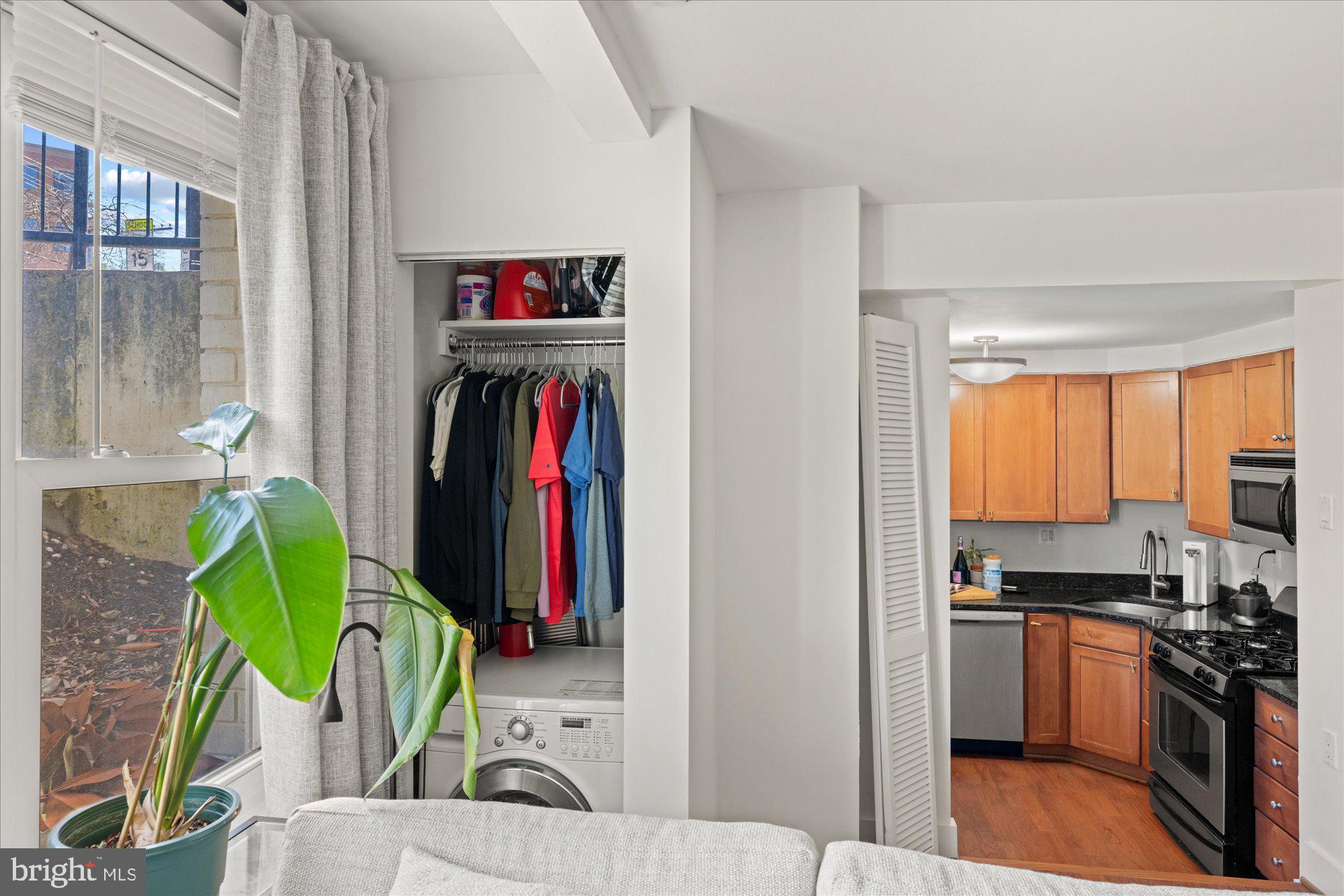 4840 MacArthur Boulevard Northwest, Unit 301 Washington, DC 20007 - Photo 21 of 24 a kitchen with stainless steel appliances kitchen island granite countertop a refrigerator and a sink
