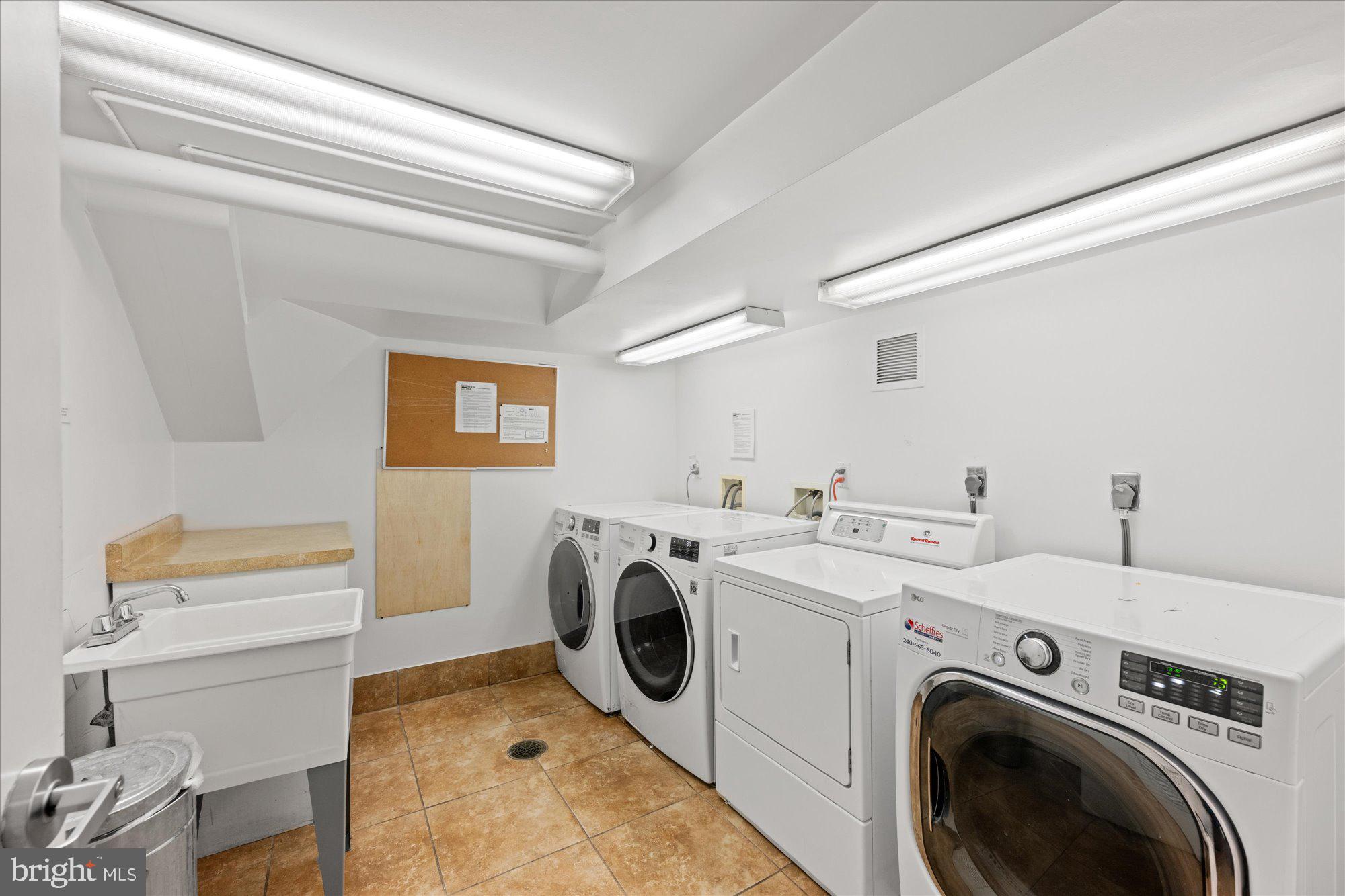 4840 MacArthur Boulevard Northwest, Unit 301 Washington, DC 20007 - Photo 22 of 24 a utility room with dryer and washer