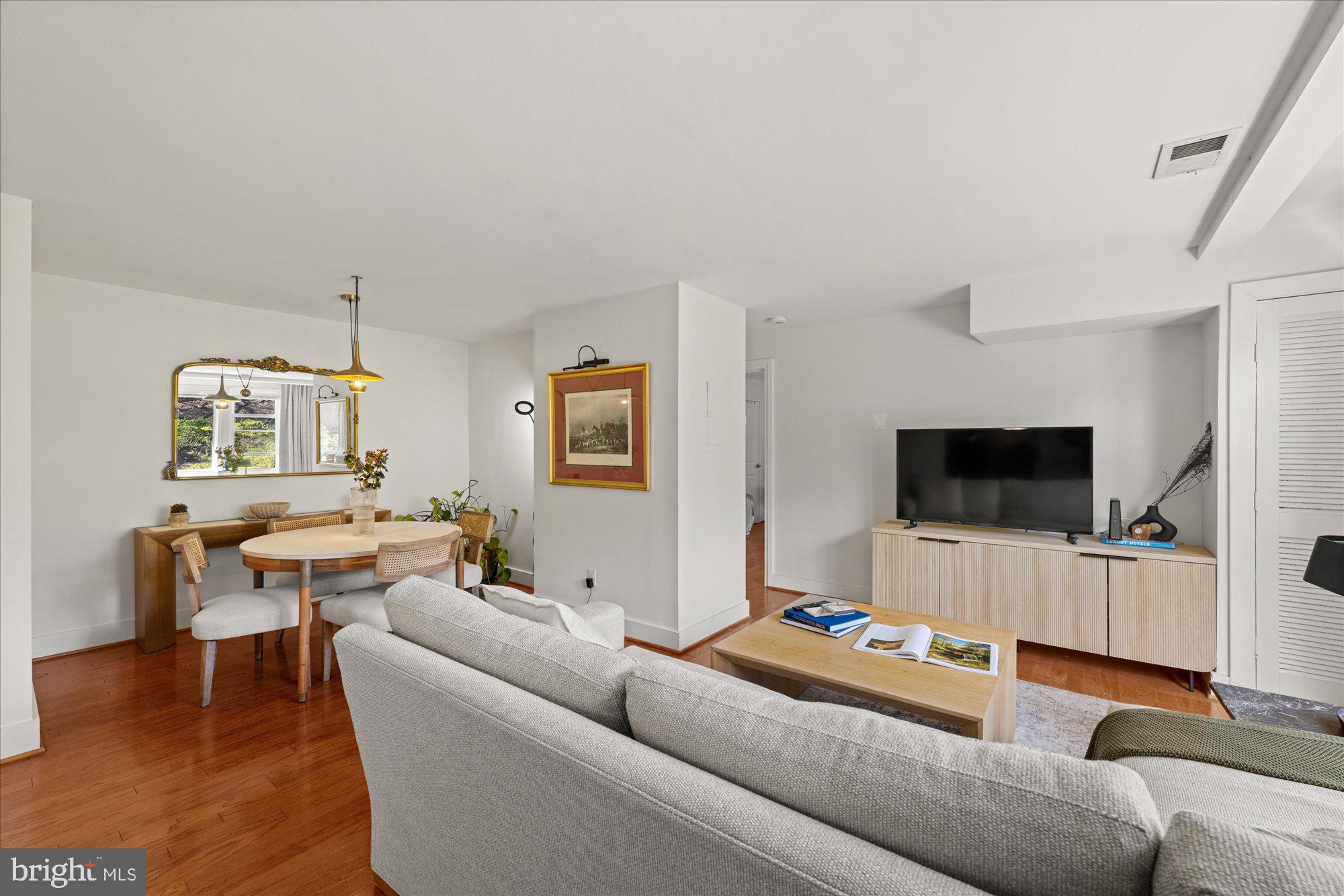 4840 MacArthur Boulevard Northwest, Unit 301 Washington, DC 20007 - Photo 7 of 24 a living room with furniture and a flat screen tv