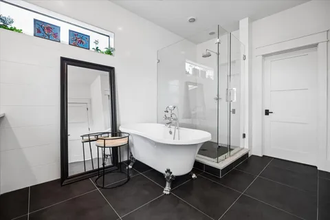 a spacious bathroom with a sink a mirror and a shower