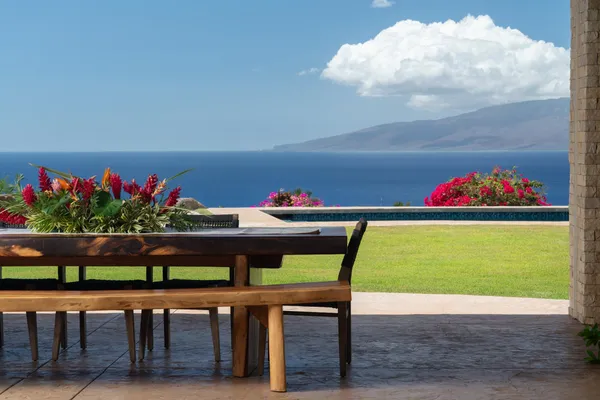 a table with flowers and a chair