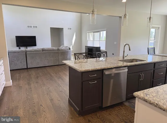a spacious bathroom with a granite countertop sink a mirror and a bathtub