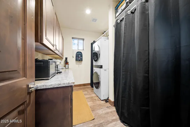 a bathroom with a granite countertop double vanity and a shower