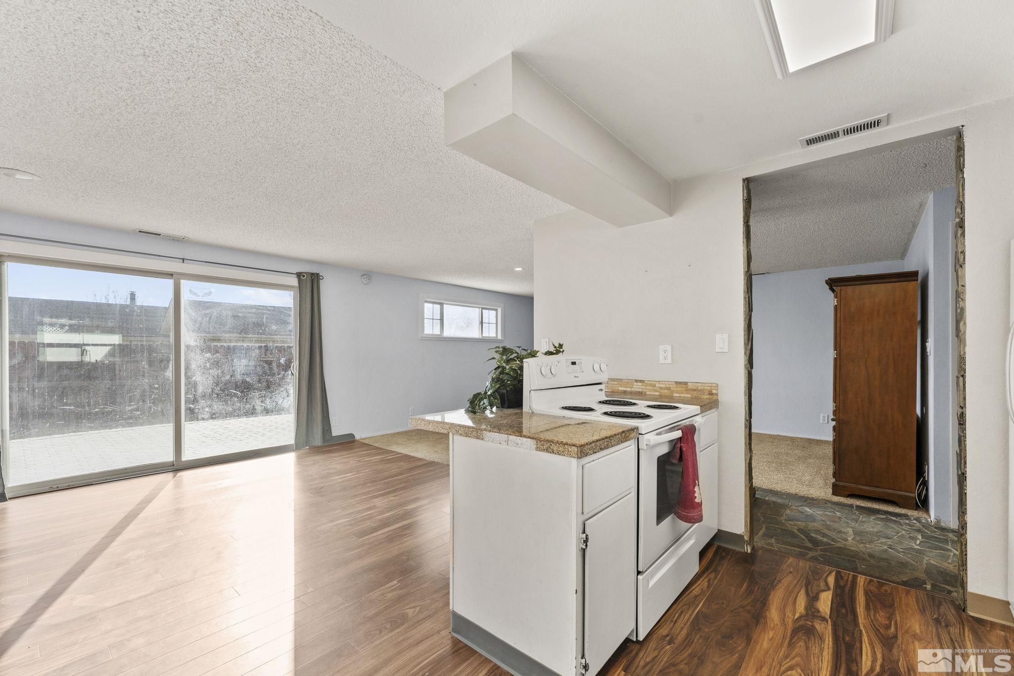 3810 Snipe Drive Reno, NV 89508 - Photo 3 of 38 a view of a kitchen with stove and wooden floor