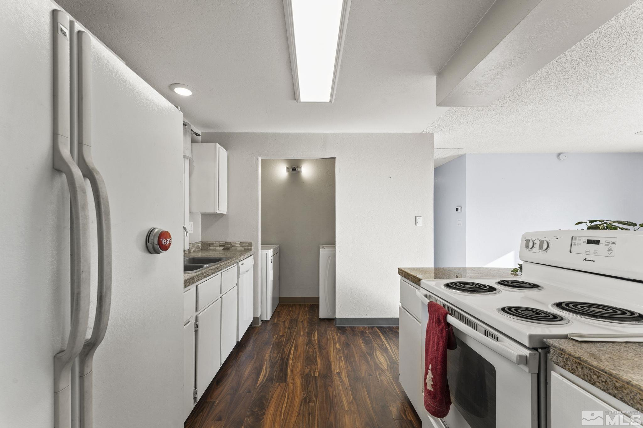 3810 Snipe Drive Reno, NV 89508 - Photo 6 of 38 a kitchen with a refrigerator a stove top oven and wooden floor