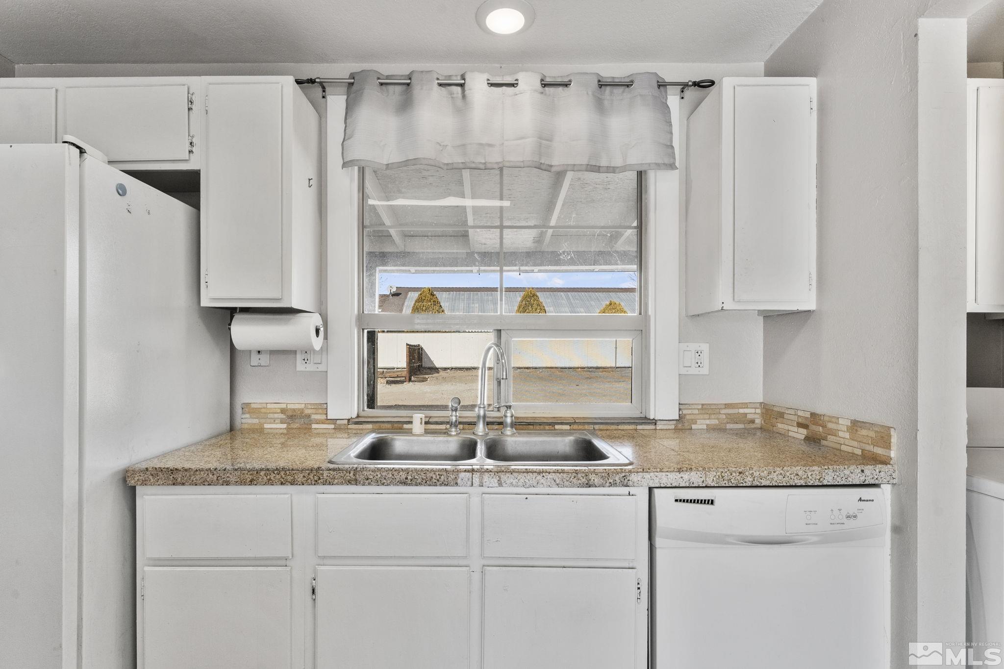 3810 Snipe Drive Reno, NV 89508 - Photo 8 of 38 a kitchen with granite countertop a refrigerator and a sink